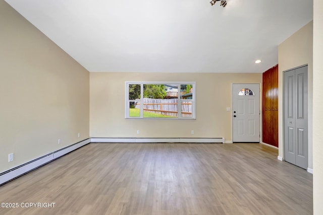 4665 Cascade Cir, Anchorage, AK 99502 - unfurnished living room with light wood-type flooring, baseboard heating, baseboards, and recessed lighting