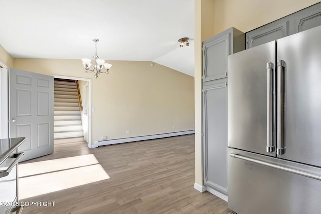 4665 Cascade Cir, Anchorage, AK 99502 - kitchen featuring high end refrigerator, a baseboard heating unit, gray cabinetry, lofted ceiling, and a chandelier