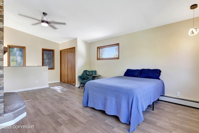 4665 Cascade Cir, Anchorage, AK 99502 - bedroom with wood finished floors, lofted ceiling, baseboard heating, baseboards, and ceiling fan