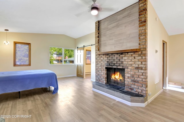 4665 Cascade Cir, Anchorage, AK 99502 - bedroom with lofted ceiling, wood finished floors, baseboards, a fireplace, and baseboard heating