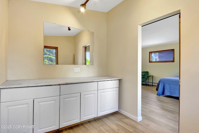 4665 Cascade Cir, Anchorage, AK 99502 - corridor featuring light wood-style flooring, baseboard heating, and baseboards