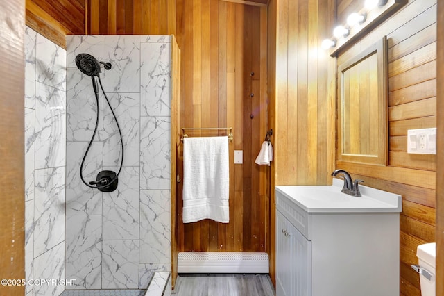 4665 Cascade Cir, Anchorage, AK 99502 - bathroom featuring a shower stall, vanity, wood walls, and baseboard heating