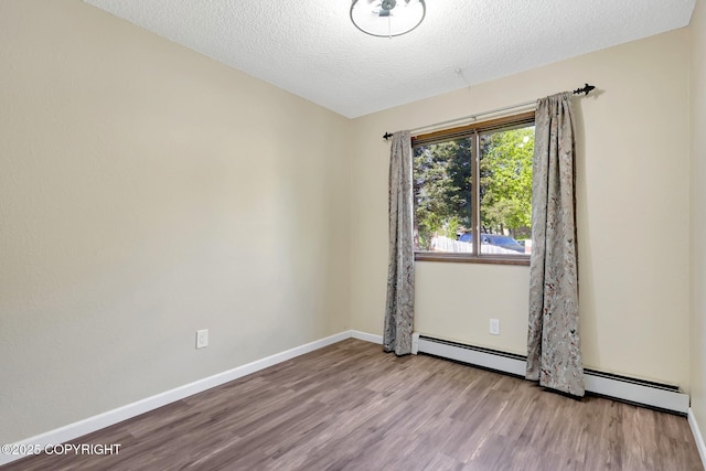4665 Cascade Cir, Anchorage, AK 99502 - empty room featuring wood finished floors, a textured ceiling, baseboards, and baseboard heating