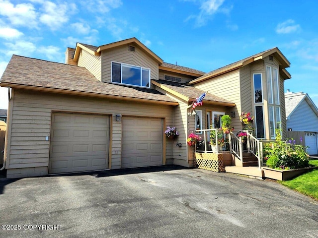 10410 Constitution St, Anchorage, AK 99515 - view of front of house featuring asphalt driveway, a garage, and a shingled roof