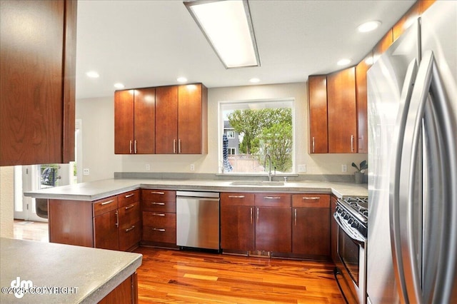 10410 Constitution St, Anchorage, AK 99515 - kitchen with stainless steel appliances, a sink, light wood finished floors, light countertops, and recessed lighting
