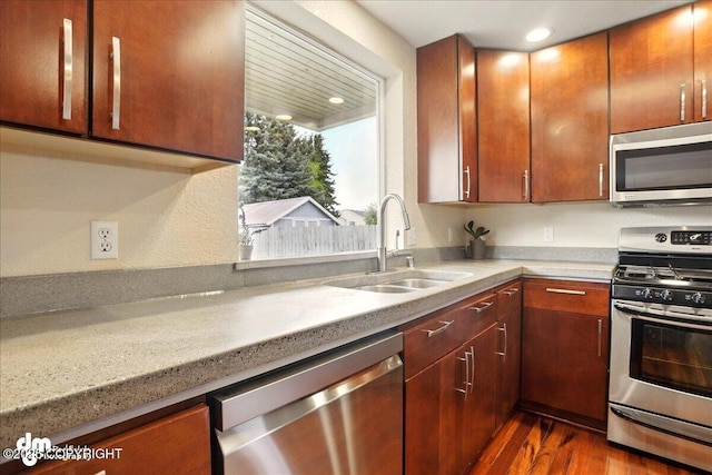 10410 Constitution St, Anchorage, AK 99515 - kitchen featuring appliances with stainless steel finishes, a sink, dark wood-type flooring, light countertops, and recessed lighting
