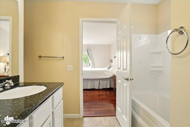10410 Constitution St, Anchorage, AK 99515 - bathroom with ensuite bathroom, vanity, shower / washtub combination, and baseboards