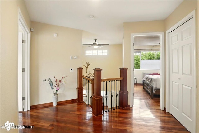 10410 Constitution St, Anchorage, AK 99515 - hall featuring dark wood-style flooring, an upstairs landing, and baseboards