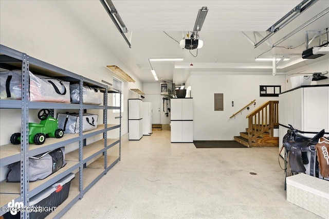 10410 Constitution St, Anchorage, AK 99515 - garage with electric panel, freestanding refrigerator, and a garage door opener