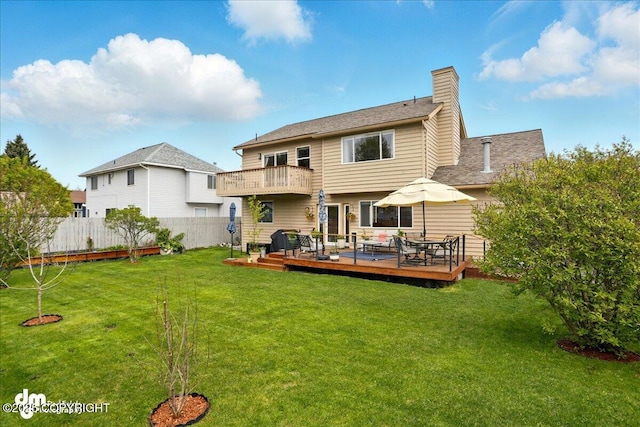 10410 Constitution St, Anchorage, AK 99515 - rear view of house featuring a wooden deck, a chimney, and a balcony
