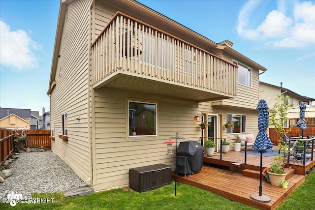 10410 Constitution St, Anchorage, AK 99515 - back of house with a fenced backyard, a balcony, and a wooden deck