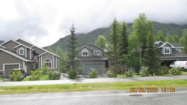 20638 Driftwood Bay Dr, Eagle River, AK 99577 - view of front of house featuring a mountain view and a garage