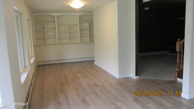 20638 Driftwood Bay Dr, Eagle River, AK 99577 - corridor featuring wood finished floors, a baseboard radiator, and baseboards
