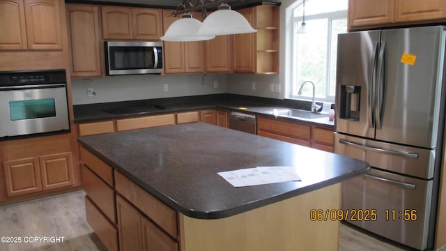 20638 Driftwood Bay Dr, Eagle River, AK 99577 - kitchen with appliances with stainless steel finishes, a sink, dark countertops, and a center island
