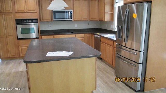 20638 Driftwood Bay Dr, Eagle River, AK 99577 - kitchen with stainless steel appliances, dark countertops, light wood finished floors, and a center island