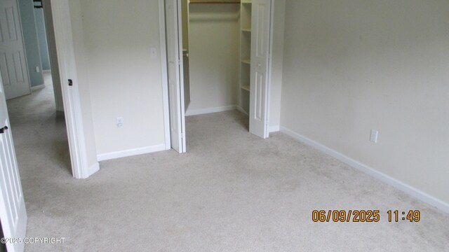 20638 Driftwood Bay Dr, Eagle River, AK 99577 - unfurnished bedroom with carpet flooring, a closet, and baseboards