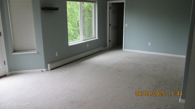 20638 Driftwood Bay Dr, Eagle River, AK 99577 - empty room featuring a baseboard heating unit, carpet flooring, and baseboards