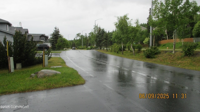 20638 Driftwood Bay Dr, Eagle River, AK 99577 - view of asphalt street featuring street lighting
