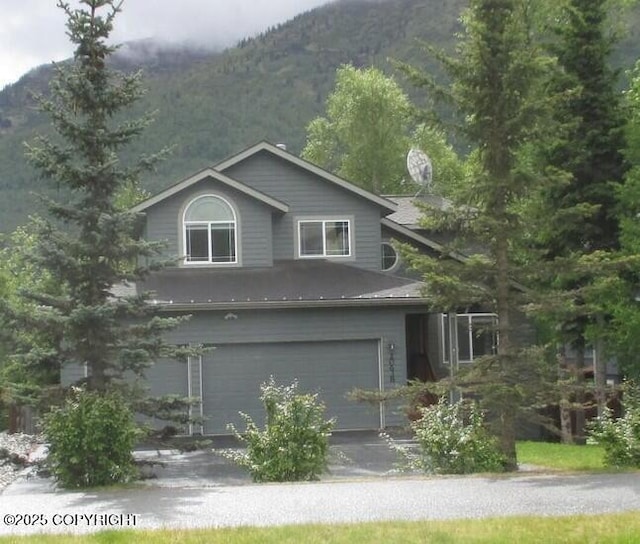 20638 Driftwood Bay Dr, Eagle River, AK 99577 - view of front of property with a mountain view, a garage, and asphalt driveway