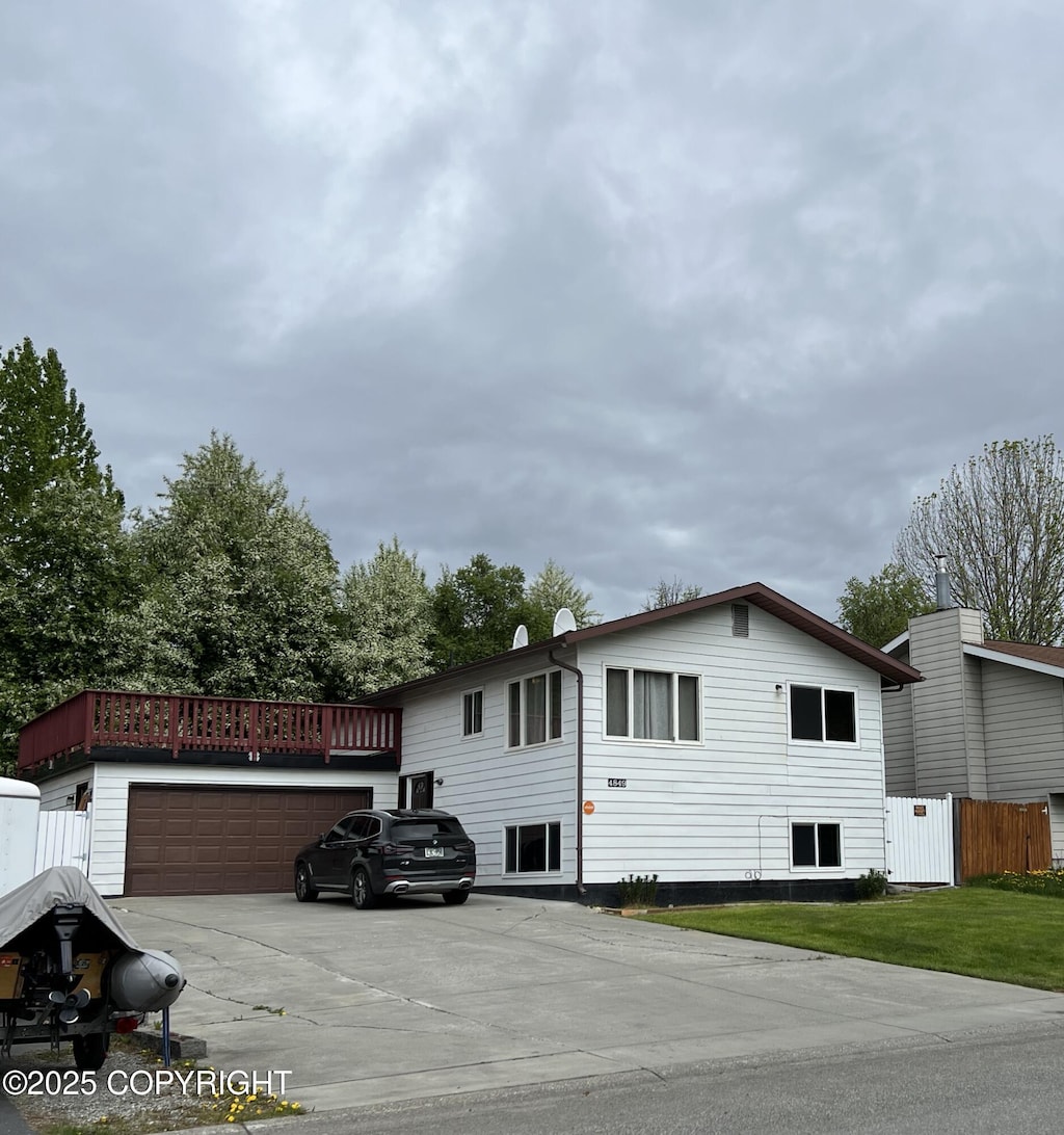 4849 E 6th Ave, Anchorage, AK 99508 - view of side of property with driveway and an attached garage