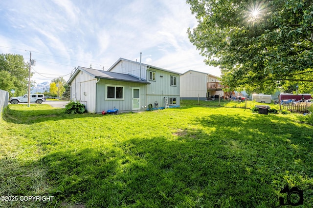 639 E Beaver Ave, Palmer, AK 99645 - back of property with board and batten siding and a lawn