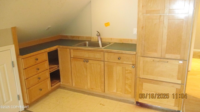 2024 Oxbow Cir, Anchorage, AK 99516 - kitchen with lofted ceiling, dark countertops, light floors, and light brown cabinets