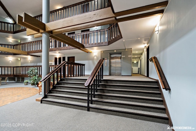 836 M St # 215, Anchorage, AK 99501 - stairs with a high ceiling, carpet flooring, and decorative columns
