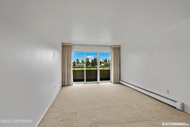 836 M St # 215, Anchorage, AK 99501 - unfurnished room featuring a baseboard heating unit, carpet floors, and baseboards