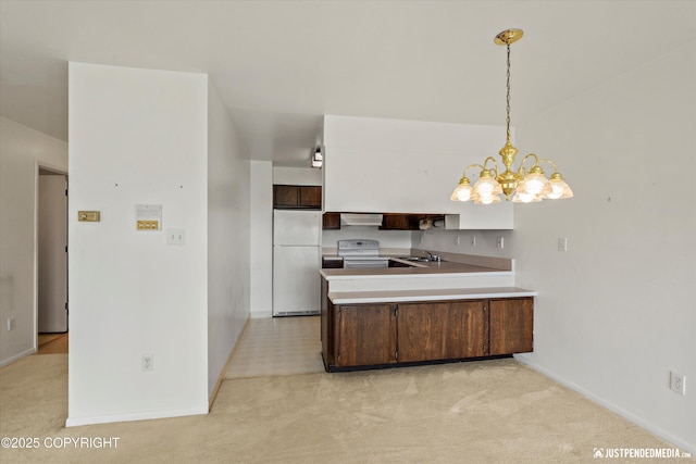 836 M St # 215, Anchorage, AK 99501 - kitchen featuring white appliances, a peninsula, a chandelier, light colored carpet, and ventilation hood
