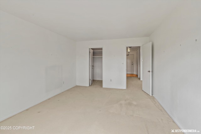836 M St # 215, Anchorage, AK 99501 - unfurnished bedroom with light carpet, baseboards, a walk in closet, and a closet
