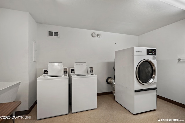 836 M St # 215, Anchorage, AK 99501 - community laundry room featuring washing machine and dryer and baseboards