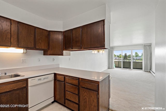 836 M St # 215, Anchorage, AK 99501 - kitchen with white dishwasher, light countertops, dark brown cabinets, and light colored carpet