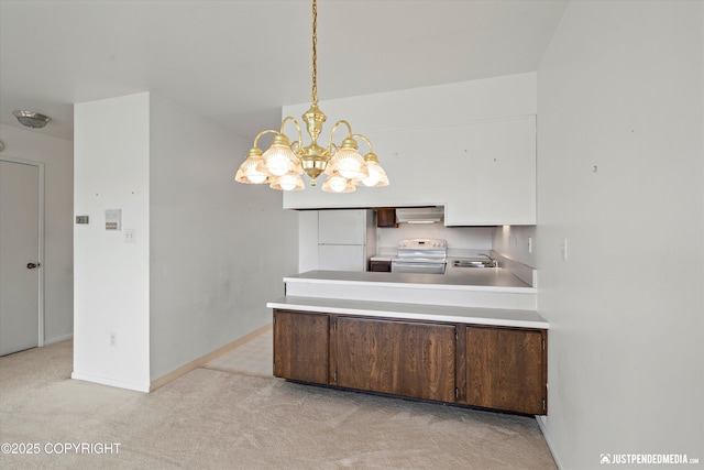 836 M St # 215, Anchorage, AK 99501 - kitchen featuring white appliances, extractor fan, light carpet, a chandelier, and a peninsula