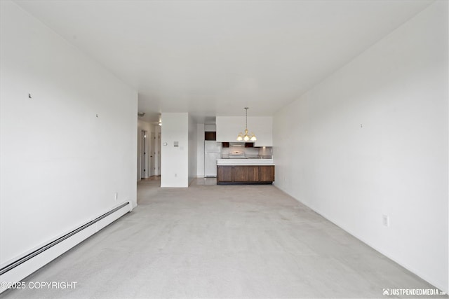 836 M St # 215, Anchorage, AK 99501 - unfurnished living room with a baseboard radiator, a chandelier, and light carpet