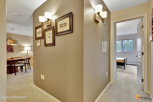 1200 I St # 206, Anchorage, AK 99501 - hallway with light carpet, baseboards, and a baseboard radiator