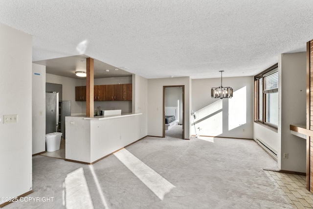 1003 Wildrose Ct # 1003, Anchorage, AK 99518 - unfurnished living room featuring a baseboard radiator, a chandelier, a textured ceiling, baseboards, and light colored carpet
