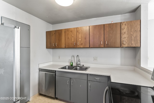 1003 Wildrose Ct # 1003, Anchorage, AK 99518 - kitchen with stainless steel appliances, a sink, light countertops, and brown cabinets