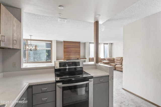 1003 Wildrose Ct # 1003, Anchorage, AK 99518 - kitchen with electric stove, gray cabinets, light countertops, carpet floors, and a textured ceiling