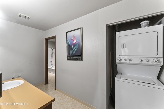 1003 Wildrose Ct # 1003, Anchorage, AK 99518 - laundry area featuring stacked washer / drying machine and baseboards