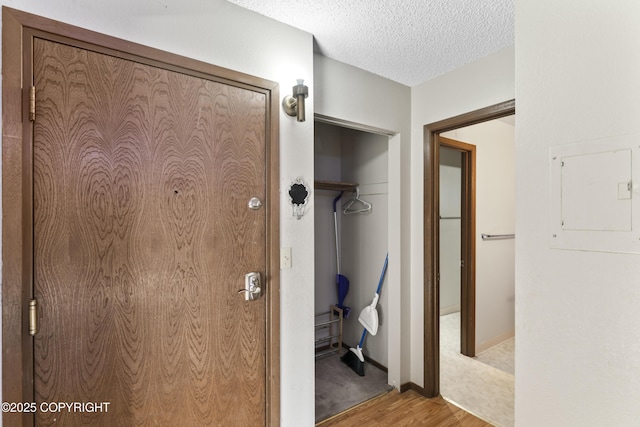 1003 Wildrose Ct # 1003, Anchorage, AK 99518 - hall with wood finished floors, a textured ceiling, and baseboards