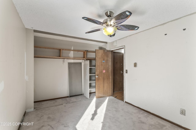 1003 Wildrose Ct # 1003, Anchorage, AK 99518 - unfurnished bedroom featuring a closet, baseboards, carpet floors, a ceiling fan, and a textured ceiling
