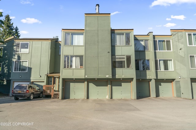 1003 Wildrose Ct # 1003, Anchorage, AK 99518 - view of building exterior featuring a garage and driveway