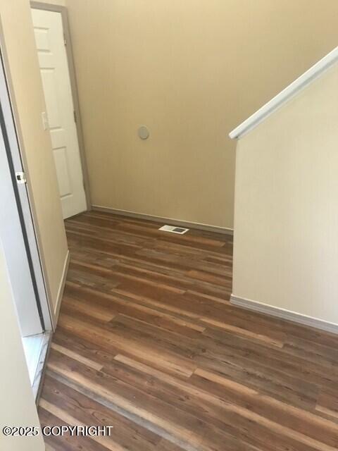 6334 Rose Hip Cir, Anchorage, AK 99507 - corridor with dark wood-type flooring and baseboards