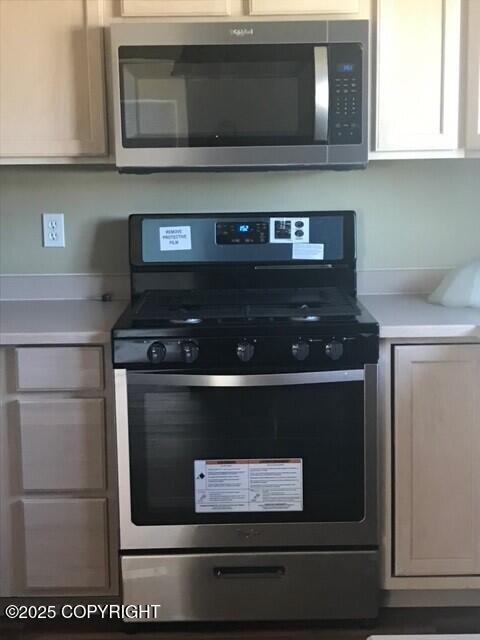 6334 Rose Hip Cir, Anchorage, AK 99507 - kitchen with appliances with stainless steel finishes and light countertops