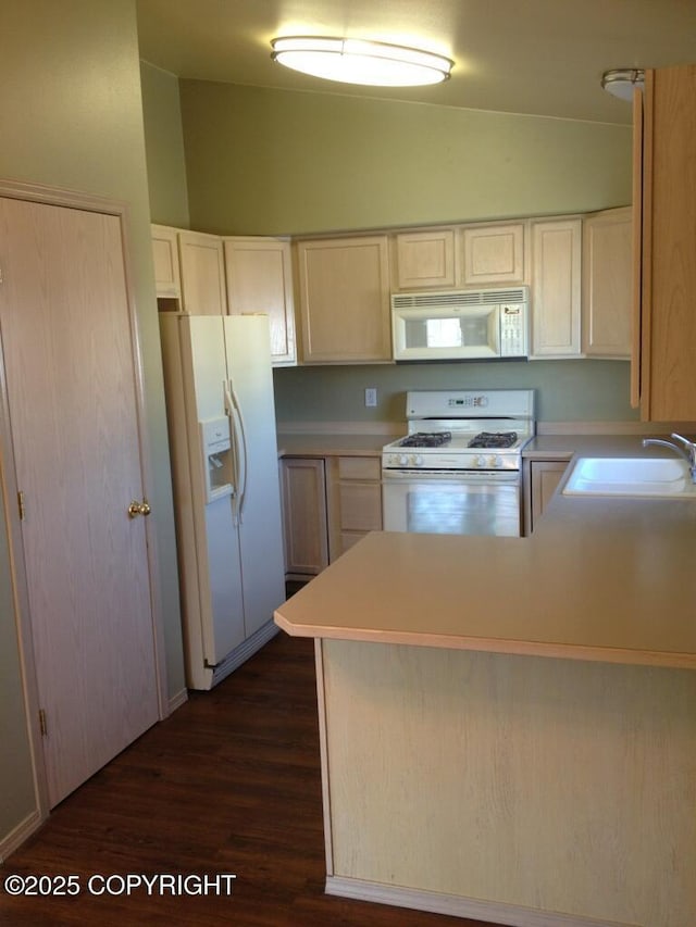 6334 Rose Hip Cir, Anchorage, AK 99507 - kitchen featuring white appliances, vaulted ceiling, dark wood-style floors, a peninsula, and light countertops