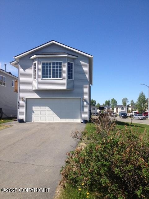 6334 Rose Hip Cir, Anchorage, AK 99507 - view of front of property with an attached garage and driveway