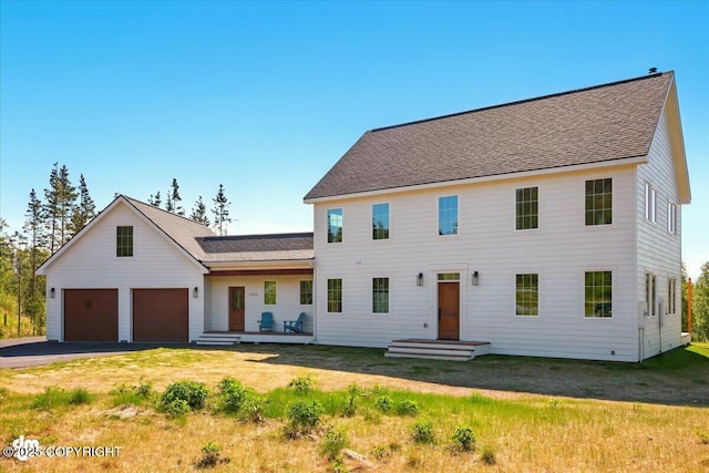 7350 E Narnia Cir, Palmer, AK 99645 - view of front facade featuring a garage, asphalt driveway, a shingled roof, and a front yard