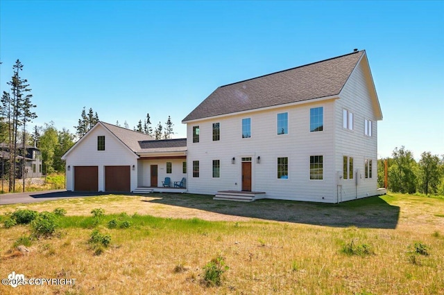 7350 E Narnia Cir, Palmer, AK 99645 - colonial home featuring a front lawn, driveway, an attached garage, and roof with shingles