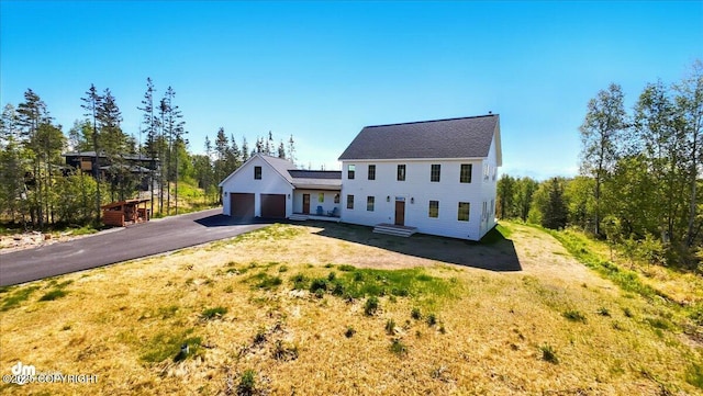 7350 E Narnia Cir, Palmer, AK 99645 - view of front of house featuring asphalt driveway, a garage, and a front yard