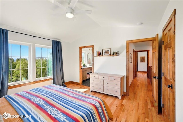 7350 E Narnia Cir, Palmer, AK 99645 - bedroom with lofted ceiling, light wood-style floors, baseboards, a ceiling fan, and connected bathroom